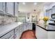 Bright kitchen features gray cabinets, quartz countertops, stainless steel appliances, and hardwood flooring at 3380 Pawleys N Loop, St Cloud, FL 34769