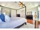 Bright main bedroom with hardwood floors, tray ceilings, and a large window at 3380 Pawleys N Loop, St Cloud, FL 34769