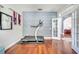 Contemporary office with a blue accent wall, a treadmill, hardwood floors, and an arched doorway at 3380 Pawleys N Loop, St Cloud, FL 34769