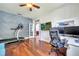 Stylish office with a treadmill, built in shelves, multiple monitors, and hardwood floors for work and fitness at 3380 Pawleys N Loop, St Cloud, FL 34769