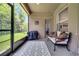 This screened patio includes a comfortable sofa and a grill for entertaining at 3380 Pawleys N Loop, St Cloud, FL 34769