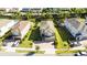 Aerial view of a home with a green lawn, surrounded by well-maintained landscaping and neighboring houses at 341 Falls Dr, Kissimmee, FL 34747