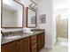 Bathroom with double vanity, granite countertops, and tiled walk-in shower offers a luxurious experience at 341 Falls Dr, Kissimmee, FL 34747