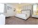 Stylish bedroom featuring a plush bed, patterned accent wall, and contemporary furnishings at 341 Falls Dr, Kissimmee, FL 34747