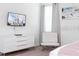Bright bedroom with a dresser, chair and mounted television offering a comfortable living space at 341 Falls Dr, Kissimmee, FL 34747