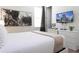 Well-lit bedroom includes a modern dresser, artwork, and bright window with dark curtains at 341 Falls Dr, Kissimmee, FL 34747