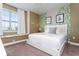 Well-lit bedroom features leafy wallpaper, a window seat, and a bed with a white bedframe at 341 Falls Dr, Kissimmee, FL 34747