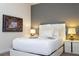 This bedroom features a modern design with a gray accent wall and minimalist decor at 341 Falls Dr, Kissimmee, FL 34747