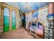 Whimsical castle-themed bedroom featuring a unique bunk bed and hand-painted mural on the walls and ceiling at 341 Falls Dr, Kissimmee, FL 34747