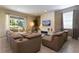 Comfortable living room featuring a large sectional sofa, accent wall, and view of the backyard at 341 Falls Dr, Kissimmee, FL 34747