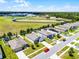 Community aerial showcasing manicured lawns, modern homes, and community athletic fields under a bright sky at 3519 Fernanda Dr, Deltona, FL 32738