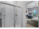 Shower with a glass door is adjacent to the bedroom featuring a fireplace and TV at 3519 Fernanda Dr, Deltona, FL 32738
