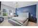 Stylish bedroom boasts a tufted platform bed, accent wall, and a modern light fixture at 3519 Fernanda Dr, Deltona, FL 32738