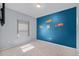 bedroom with blue accent wall, carpeted floor, and a window with natural light at 3519 Fernanda Dr, Deltona, FL 32738