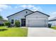 Charming single-Gathering home with well-manicured lawn and an attached two-car garage at 3519 Fernanda Dr, Deltona, FL 32738