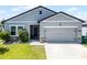 Charming single-Gathering home with well-manicured lawn and an attached two-car garage at 3519 Fernanda Dr, Deltona, FL 32738
