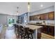 Modern kitchen with granite countertops, stainless steel appliances, and a breakfast bar with seating at 3519 Fernanda Dr, Deltona, FL 32738