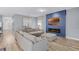 Comfortable living room with a blue accent wall, fireplace, and a spacious sectional sofa at 3519 Fernanda Dr, Deltona, FL 32738