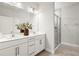 Bathroom featuring a double vanity, a large mirror, and a glass-enclosed shower at 3981 Great Smokey Way, Apopka, FL 32712