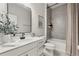 Modern bathroom showcasing a sleek vanity, a decorative mirror, and a tiled shower with a tub at 3981 Great Smokey Way, Apopka, FL 32712