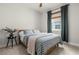 Comfortable bedroom with a striped bedspread, a small side table, and natural light from the window at 3981 Great Smokey Way, Apopka, FL 32712