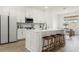 Modern kitchen featuring white cabinets, stainless steel appliances and an island with seating at 3981 Great Smokey Way, Apopka, FL 32712