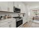 Modern kitchen featuring stainless steel appliances, quartz countertops and white cabinetry at 3981 Great Smokey Way, Apopka, FL 32712