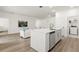 Modern kitchen featuring a central island, stainless steel appliances and wood flooring at 3981 Great Smokey Way, Apopka, FL 32712