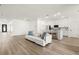 Open-concept living room and kitchen area, showcasing contemporary design and wood floors at 3981 Great Smokey Way, Apopka, FL 32712