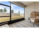 Screened patio with a chair, side table and an outdoor rug at 3981 Great Smokey Way, Apopka, FL 32712