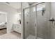 Modern shower stall with tile surround, glass door, and convenient built-in shelving at 3981 Great Smokey Way, Apopka, FL 32712