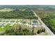 A serene aerial view of a home next to a pond, nestled within a lush, green landscape and a well-planned community at 4119 Sunset Preserve Blvd, Orlando, FL 32820