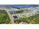 Expansive aerial view of a lakeside community with multiple ponds and manicured landscapes surrounded by lush green woods at 4119 Sunset Preserve Blvd, Orlando, FL 32820