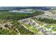 An aerial view showcasing a lakeside community with multiple ponds, landscaping, and lush green surroundings and woods at 4119 Sunset Preserve Blvd, Orlando, FL 32820