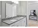 Bathroom with double sink vanity, sleek gray countertops and a glimpse of an adjacent exercise area at 4119 Sunset Preserve Blvd, Orlando, FL 32820