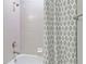 A clean bathroom shower area with white tiling and a decorative shower curtain at 4119 Sunset Preserve Blvd, Orlando, FL 32820