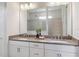 Bathroom vanity featuring dual sinks, modern fixtures, and a large mirror at 4119 Sunset Preserve Blvd, Orlando, FL 32820