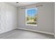 Bedroom with eye-catching accent wall and a window providing ample natural light at 4119 Sunset Preserve Blvd, Orlando, FL 32820