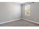 Bedroom featuring grey walls, carpeted floor, and a window at 4119 Sunset Preserve Blvd, Orlando, FL 32820