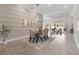 Elegant dining room featuring modern lighting, accent wall, and open floor plan at 4119 Sunset Preserve Blvd, Orlando, FL 32820