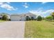 Charming single-story home with a three-car garage, featuring a brick-paved driveway at 4119 Sunset Preserve Blvd, Orlando, FL 32820