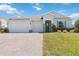 Beautiful single-story home with a three-car garage and manicured front lawn at 4119 Sunset Preserve Blvd, Orlando, FL 32820