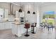 Bright kitchen features a central island, stainless steel appliances, and adjacent breakfast nook at 4119 Sunset Preserve Blvd, Orlando, FL 32820