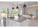 Open concept kitchen with stainless steel appliances, a center island, and backyard view at 4119 Sunset Preserve Blvd, Orlando, FL 32820