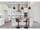 Modern kitchen with a center island, stainless steel appliances, and stylish pendant lighting at 4119 Sunset Preserve Blvd, Orlando, FL 32820