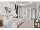 Spacious main bedroom with decorative wall accents, tray ceiling, and ensuite access at 4119 Sunset Preserve Blvd, Orlando, FL 32820