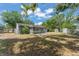 Spacious backyard with a mix of grass and shaded areas, including a screened-in porch at 439 Sunrise Ct, Orlando, FL 32803