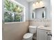 Bathroom featuring tiled walls, updated vanity, and natural light at 439 Sunrise Ct, Orlando, FL 32803