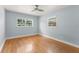 Bedroom with hardwood floors, ceiling fan, and natural light from two windows at 439 Sunrise Ct, Orlando, FL 32803