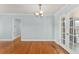 Dining room with chair rail and hardwood floors, with view to entry and kitchen at 439 Sunrise Ct, Orlando, FL 32803